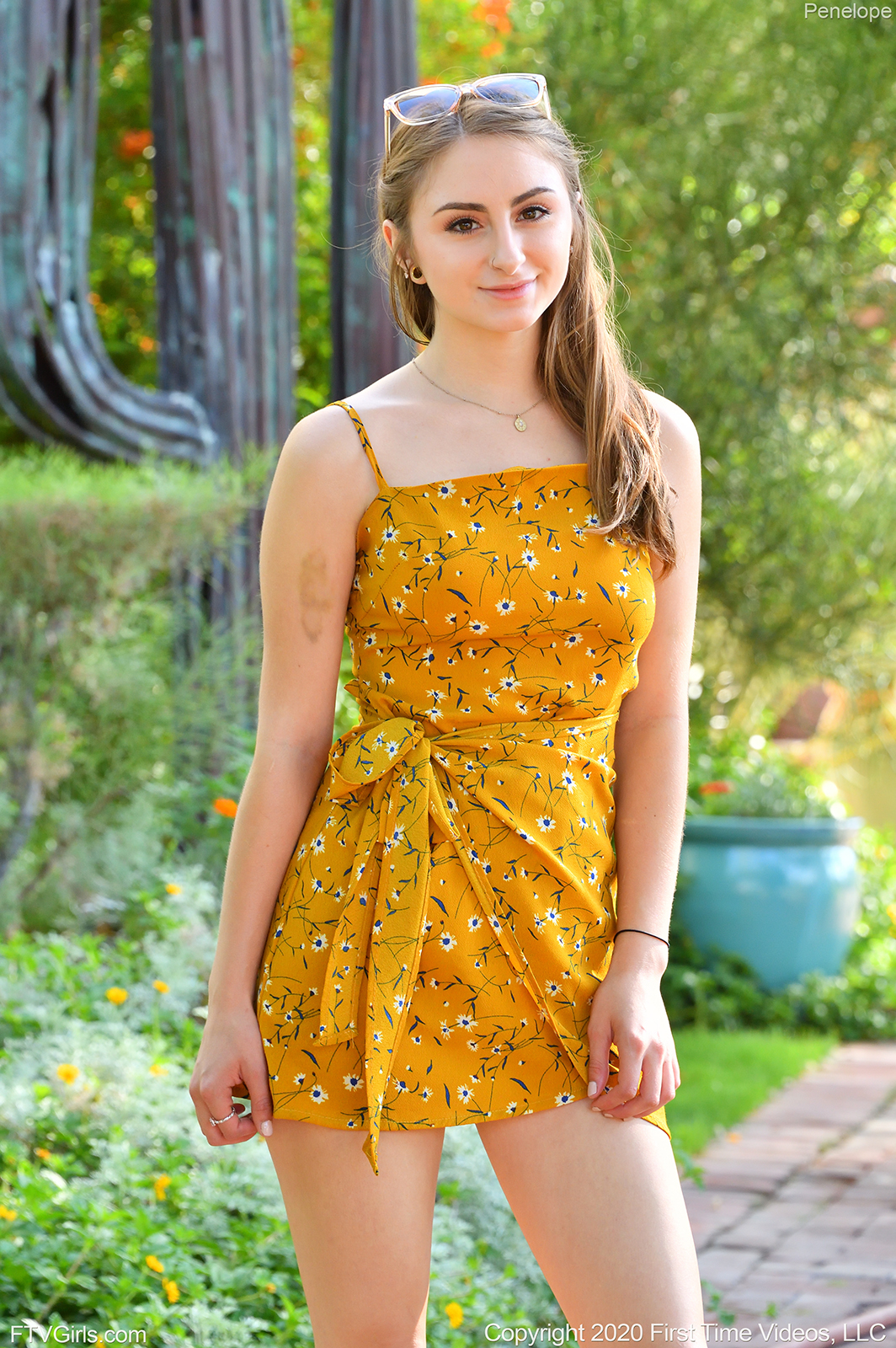 teen pornstar penelope ftv is non nude wearing a sexy dark orange floral dress while standing outdoors in Sunny Yellow