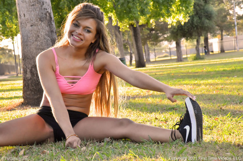 teen pornstar Destiny FTV is non nude wearing a pink sports bra while stretching out of the park in Sporty At The Park